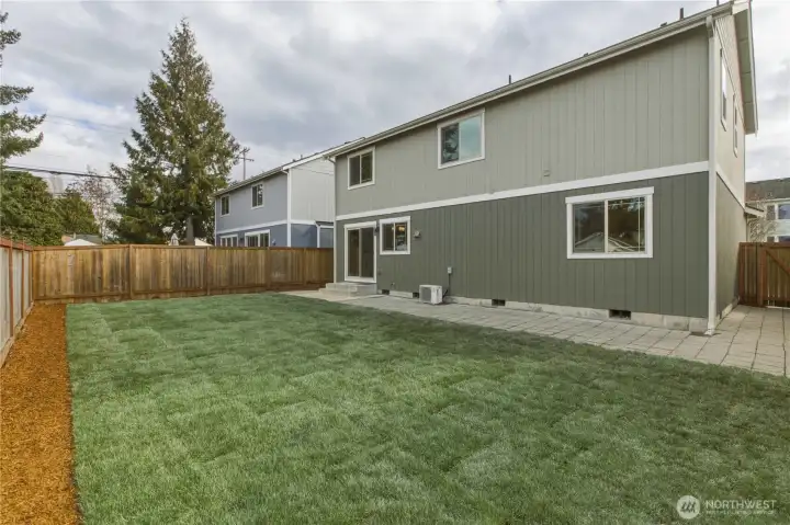 Fully Fenced back yard; luscious new sod & planting border. Patio and hard-scape that extends around the home.