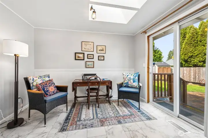 Call it a breakfast nook, call it a sunroom, call it the spot everyone gravitates toward. This bright corner of the home is absolutely glowing with skylights overhead and a slider that opens wide to the backyard, creating an effortless indoor outdoor rhythm. The current owners have smartly turned it into a cozy office lounge, proof that this room adapts beautifully to real life. beadboard wainscoting adds texture and a hint of storybook charm, while the natural light does most of the decorating for you.