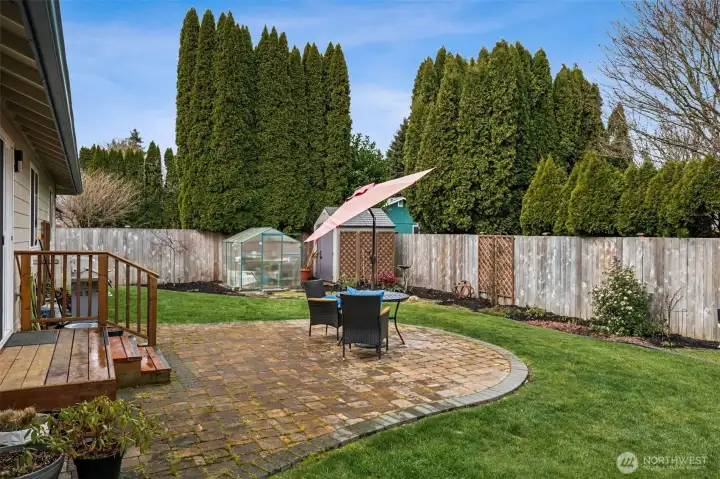 Tucked into the far corner, the shed and greenhouse combo is basically a love letter to anyone with a green thumb. Early seed starts, overwintering favorites, potting projects that somehow take over your weekends, it all has a proper home here. There is so much open yard to design garden beds, pollinator patches, or even a mini orchard moment if that’s your thing. Mature privacy hedging in the neighboring yards helps frame the space with a soft, leafy backdrop, giving this backyard a peaceful, tucked-away vibe that feels surprisingly private for everyday living.