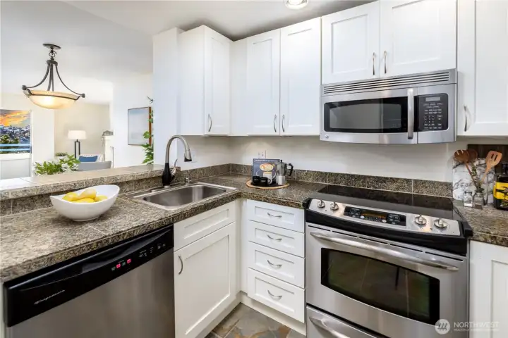 The galley kitchen keeps the connection to light and water present, shaping everyday moments and meals