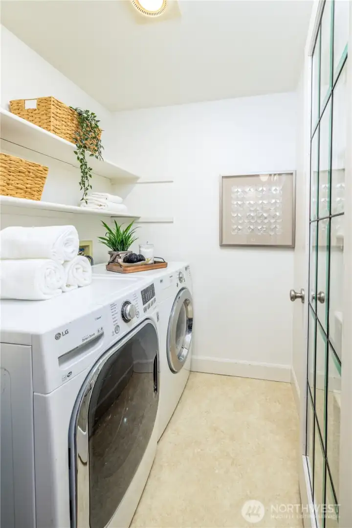 A dedicated laundry area with ample storage, complemented by a nearby coat closet and additional space off the terrace