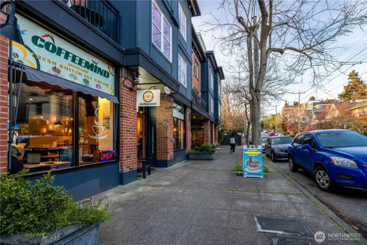 Tree-lined streets and local storefronts reflect the character and walkability of Queen Anne