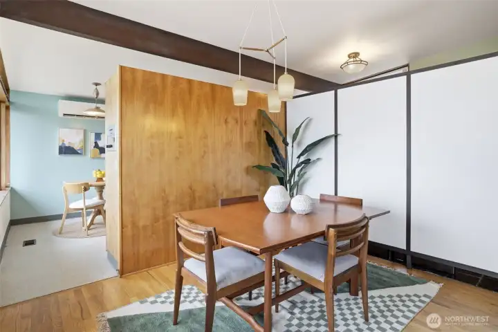 The white wall separates the entry from the dining room.