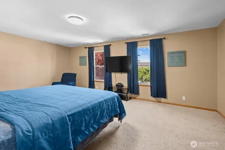 Bright And Airy Primary Suite Featuring Large Windows And Abundant Natural Light