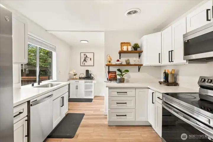 This beautifully updated kitchen comes equipped with shaker cabinets, quartz counter, eat in corner & Stainless Steel Appliances!