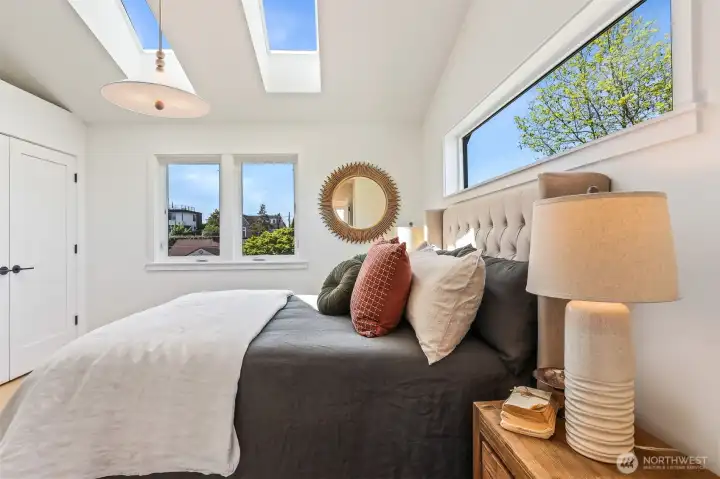Top floor primary bedroom with vaulted ceiling and skylights Top floor primary bedroom with vaulted ceiling and skylights