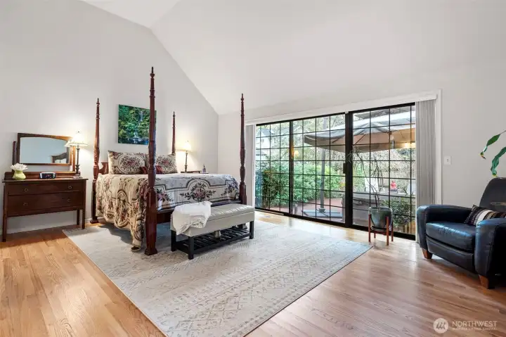 Main floor primary bedroom with patio access and blackout curtains