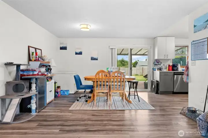 The dining area flows into the kitchen and opens to the covered patio and backyard.