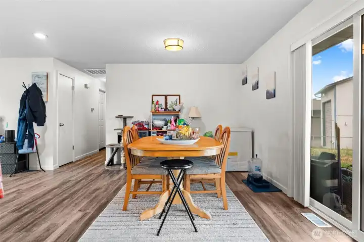 The dining area flows into the kitchen and opens to the covered patio and backyard.