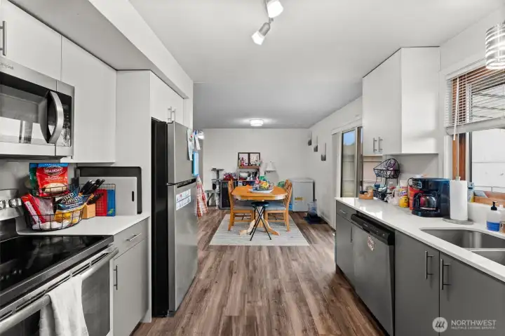 Open kitchen with updated cabinets, countertops, appliances, and fixtures!
