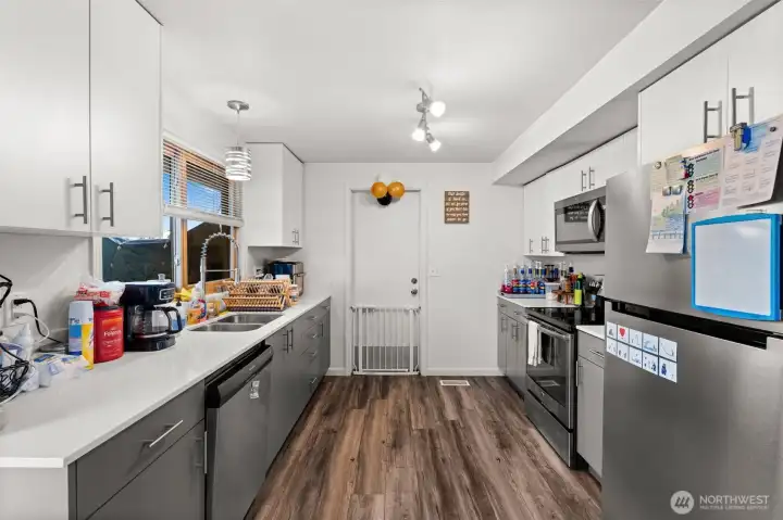 Kitchen features stainless steel appliances, solid surface countertops, and a functional layout for meal preparation.