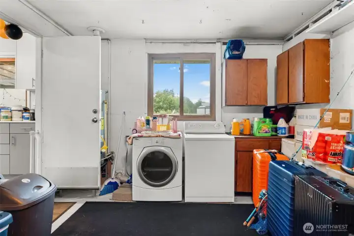 Laundry room features a practical layout with built-in storage and room for everyday essentials.