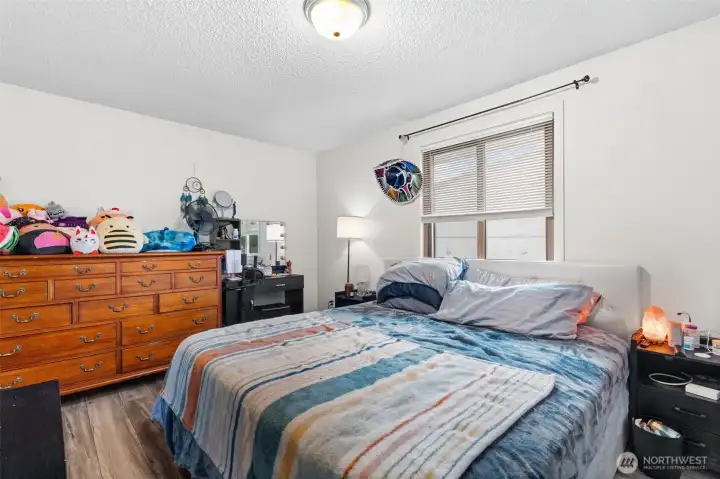 Large window and efficient layout create a functional and comfortable bedroom space.