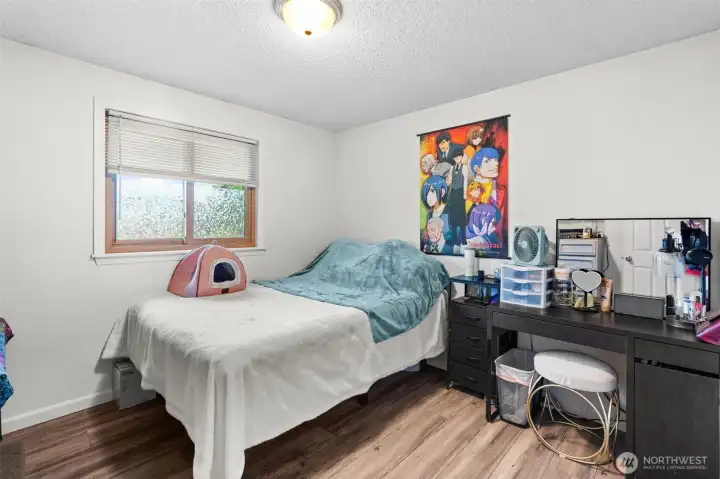 Well-proportioned bedroom offers a large window and flexible space.