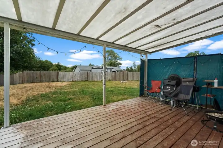 Covered outdoor patio offers a versatile space for dining, relaxing, or entertaining.