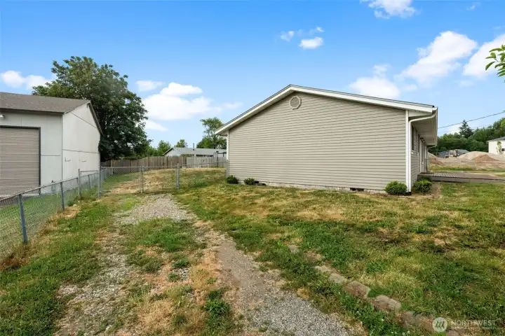 Double side gate on the West side of the home. Perfect to store toys behind or easy back yard access.