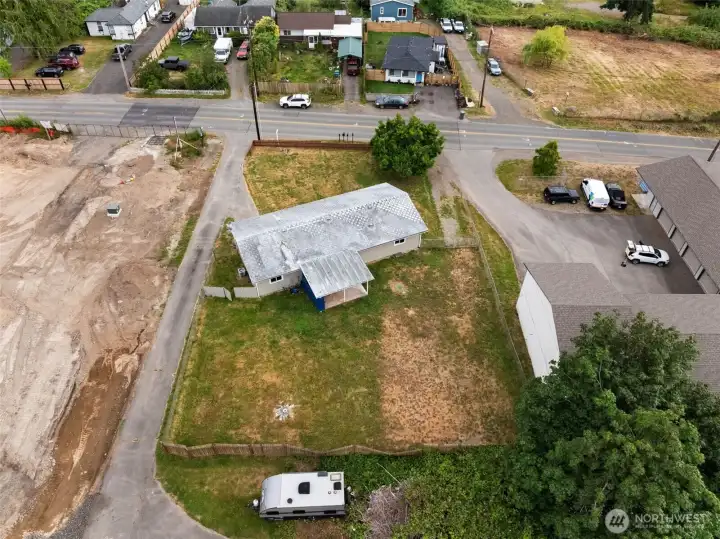 Aerial view highlights the home's generous lot size, spacious backyard, and surrounding neighborhood.