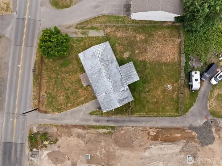 Overhead aerial view showcases the home's footprint, lot configuration, and surrounding yard space.
