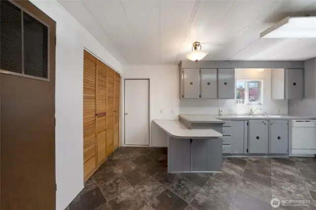 The door in the background leads to a covered patio--perfect for grilling and dining outside...or just relaxing! Laundry closet on the left, and the forced-air furnace is situated in the closet on the left foreground.