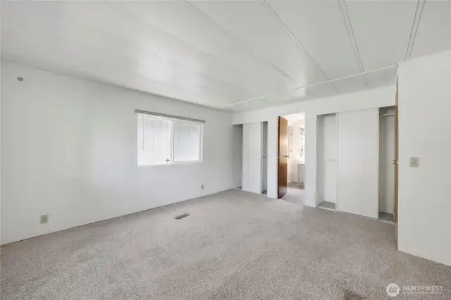 Plenty of space in the Primary Bedroom! It also features two closets with built-in shelving and a Primary Bathroom.