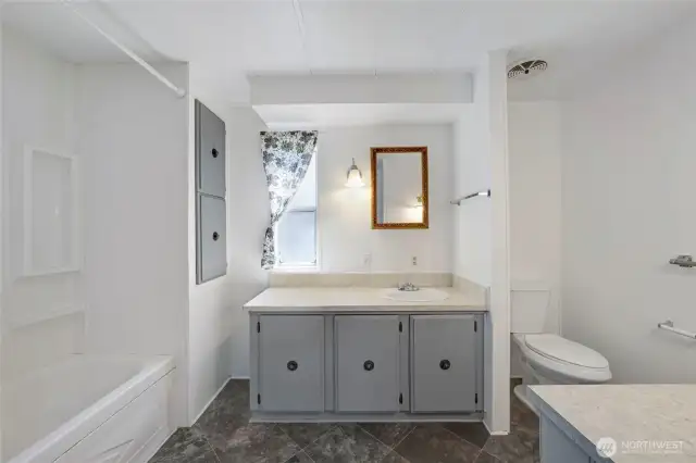Extra counter space in the Primary Bathroom with a full bath and shower.