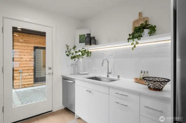 Details that shine. Under-cabinet lighting, timeless subway tile, and sleek fixtures elevate every dish you rinse or glass you pour.