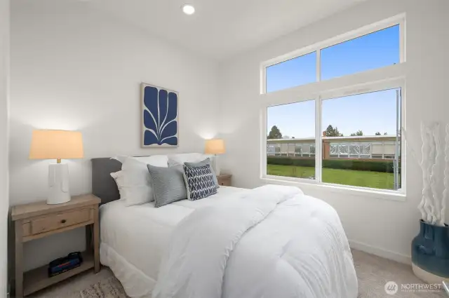 This sunlit bedroom is your peaceful retreat, with large windows that frame green views and fill the room with calming light—morning person or not, you’ll love waking up here.