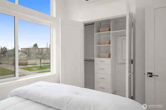 Dual closets with custom built-ins keep everything organized, and use this bright bedroom’s layout extensively.