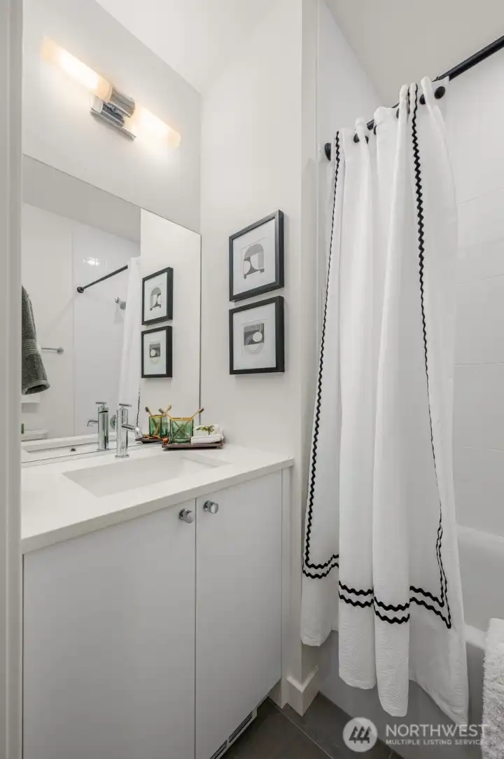 Photos of model home with similar finishes & floor plan. Crisp, modern bath with polished finishes, extra storage, and a full tub—your everyday routine just got an upgrade.