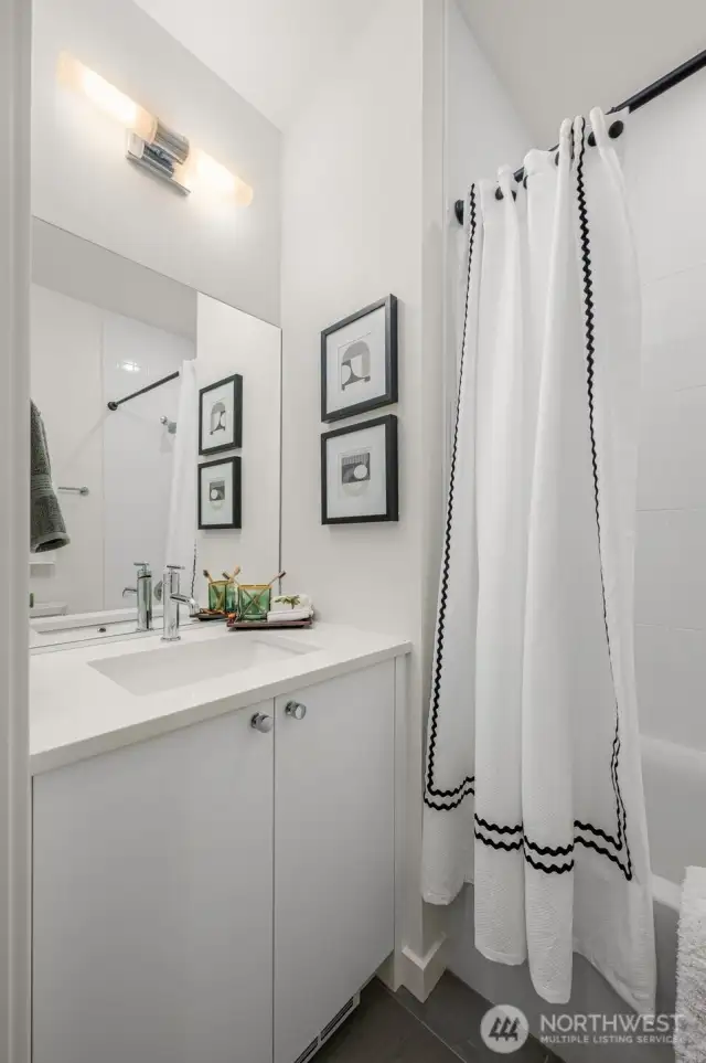 Crisp, modern bath with polished finishes, extra storage, and a full tub—your everyday routine just got an upgrade.