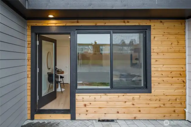 Step right in! Oversized windows and a glass-panel door fill your entry with light, while wood textures add natural warmth to the contemporary vibes.