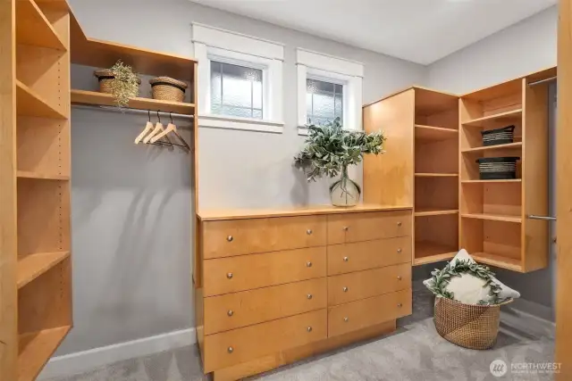 Primary walk in closet with custom built ins.
