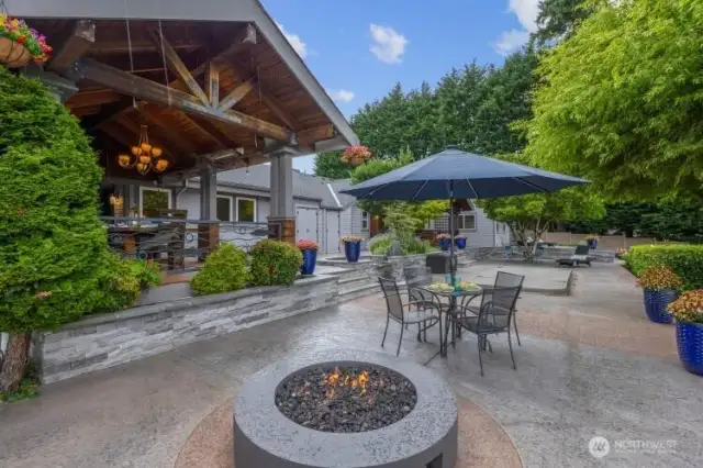 Outdoor Fire Pit hooked to gas. Outdoor dining on left looking north towards 2nd deck and lap pool