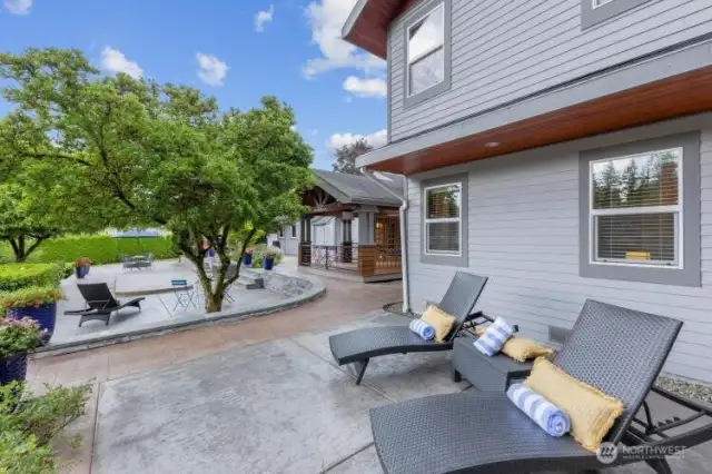 More patio space, looking south toward outdoor eating area, lap pool and firepit