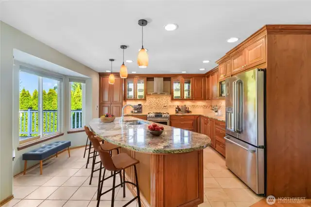 Chef’s kitchen has all the bells & whistles including Maple cabinets, huge island w/sink, bay window, tons of pull outs including a mixer cabinet that pulls out to counter level, & beautiful glass cabinets w/shelves!