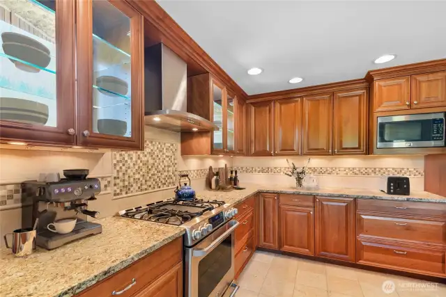 So much counter space.  The glass cabinets with shelves are a true focal point.Fantastic 2 story located in the highly sought after Tuscany neighborhood! This light & bright 4 bdrm on a huge corner lot is the one you have been waiting for! Open floor plan has a separate Living, Family, & Dining room, perfect for entertaining. Chef’s kitchen has all the bells & whistles including Maple cabinets, huge island w/sink, bay window, tons of pull outs including a mixer cabinet that pulls out to counter level, & beautiful glass cabinets w/shelves! Radiant heated travertine stone tile in the kitchen is amazing!