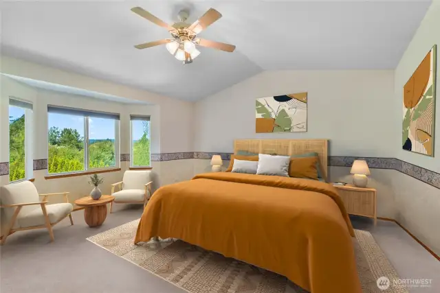 Primary bedroom is large and has a beautiful territorial view. Note the vaulted ceilings and ceiling fan.