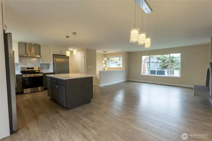 From dining room looking into kitchen and living room with fireplace.