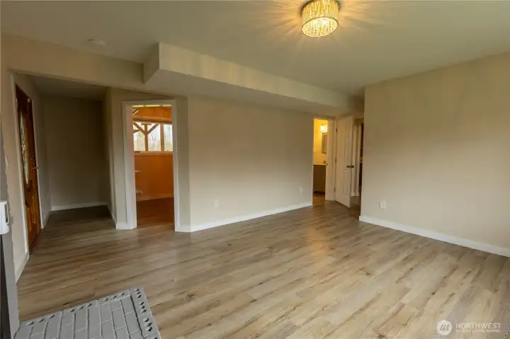 Another view of downstairs primary - showing outside entrance, walk in closet, and private bath.