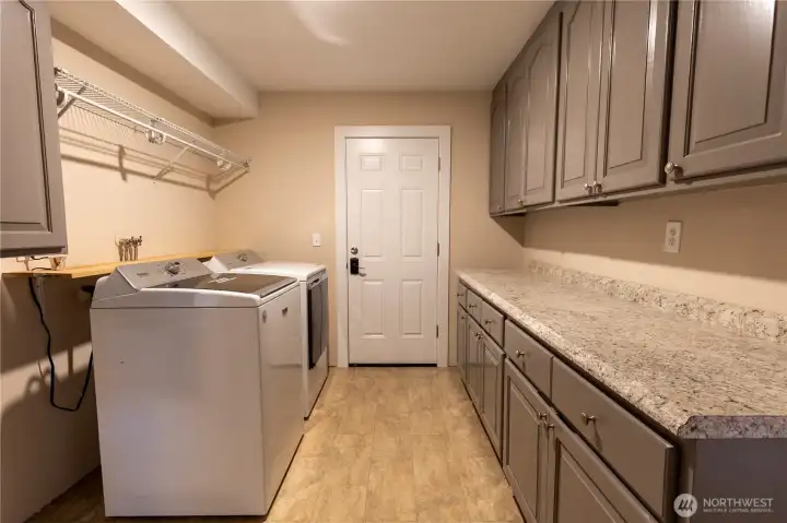 Laundry room showing door to back patio.
