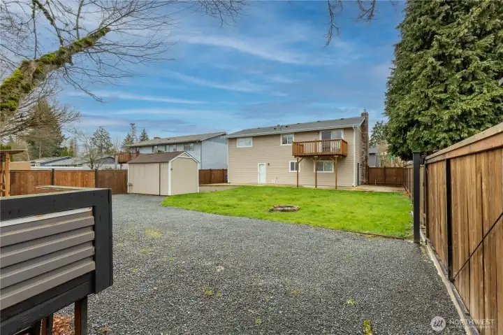 Back of home showing deck. Outbuilding with power. fully fenced yard.