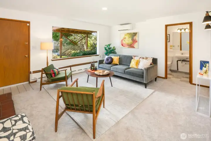 On the daylight lower level, you'll find this awesome rec room with generous ceiling height. The walk out to the backyard is to the left in this photo. Bathroom and bedroom are to the right.