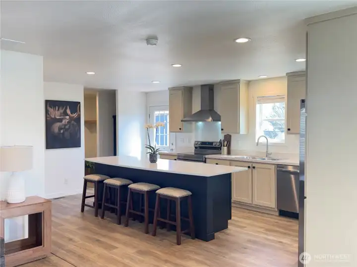Kitchen, utility room entry, and back door from living room.