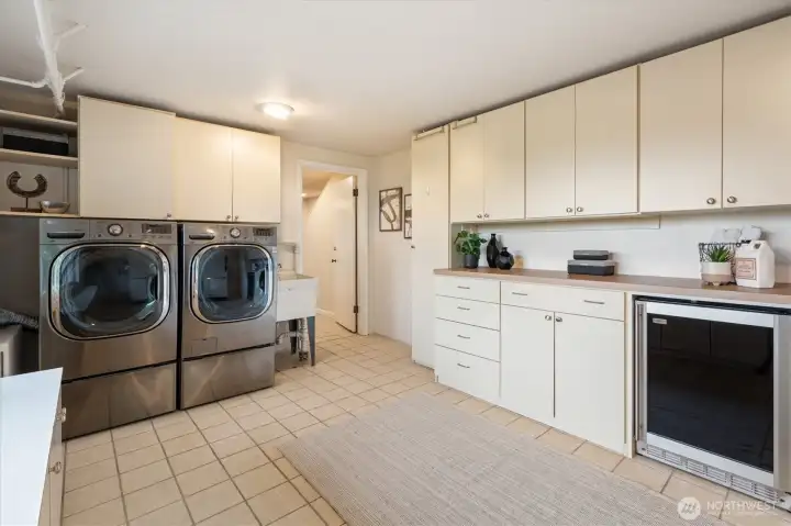 Utility room with w/d, wine fridge, full fridge and built in storage