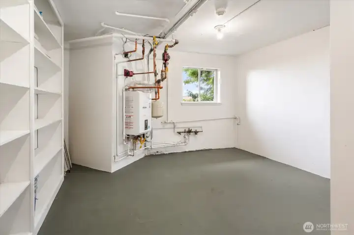 Lower level boiler room with lots of storage and built in shelves