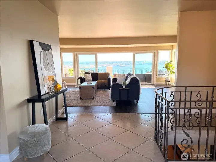 Welcoming entry opens to a stunning living room with a fireplace and expansive windows that capture breathtaking views in every season