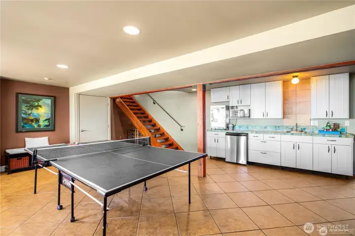 Game area kitchenette stocked with a popcorn machine, cookie warmer, sink, and dishwasher—ideal for family fun and casual entertaining.