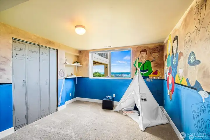 Showcasing an amazing sports mural, Bedroom #4 offers a lively and inspiring space for kids or sports enthusiasts.