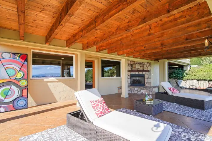 Enjoy outdoor living with a covered patio on the lower level, complete with a gas fireplace for cozy gatherings and relaxing evenings.