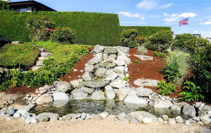 Beautiful waterfall pond wired and ready to convert into a relaxing hot tub—combining tranquility with luxury.